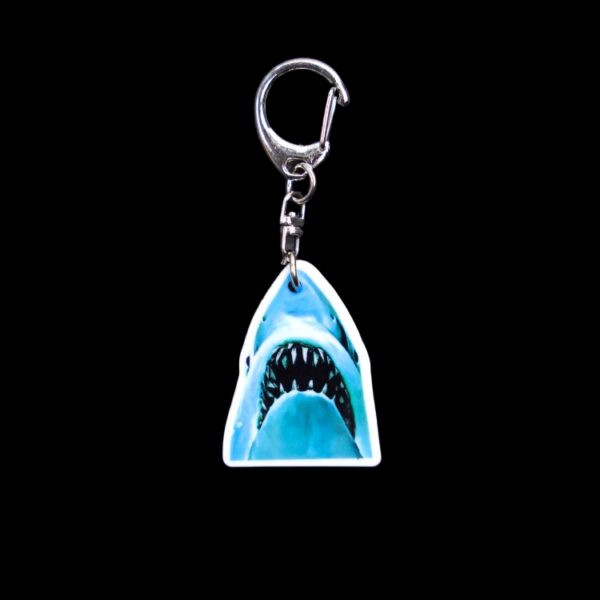 Jaws Bag Tag. This bag tag is made with acrylic and heat pressed. Comes with lobster clasp topper that easily hooks to a bag, zippers, and lanyards for fun display and swivels. White backside.