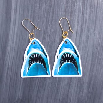 Jaws Earrings. These earrings are made with acrylic and hand heat pressed. Comes with 18k plated gold hooks that is nickel free. Easily put loop through ear and hook back so the earring doesn’t fall out.