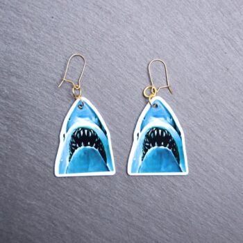 Jaws Earrings. These earrings are made with acrylic and hand heat pressed. Comes with 18k plated gold hooks that is nickel free. Easily put loop through ear and hook back so the earring doesn’t fall out.