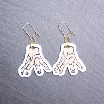 Thing Earrings. These earrings are made with acrylic and hand heat pressed. Comes with 18k plated gold hooks that is nickel free. Easily put loop through ear and hook back so the earring doesn’t fall out.