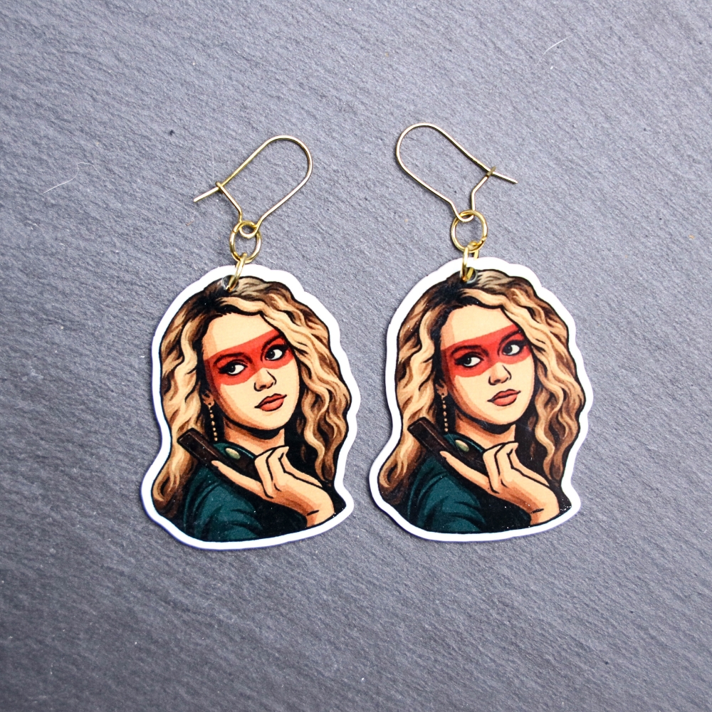 80's Killer Chick Earrings. These earrings are made with acrylic and hand heat pressed. Comes with 18k plated gold hooks that is nickel free. Easily put loop through ear and hook back so the earring doesn’t fall out.