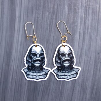 Creature Earrings. These earrings are made with acrylic and hand heat pressed. Comes with 18k plated gold hooks that is nickel free. Easily put loop through ear and hook back so the earring doesn’t fall out.