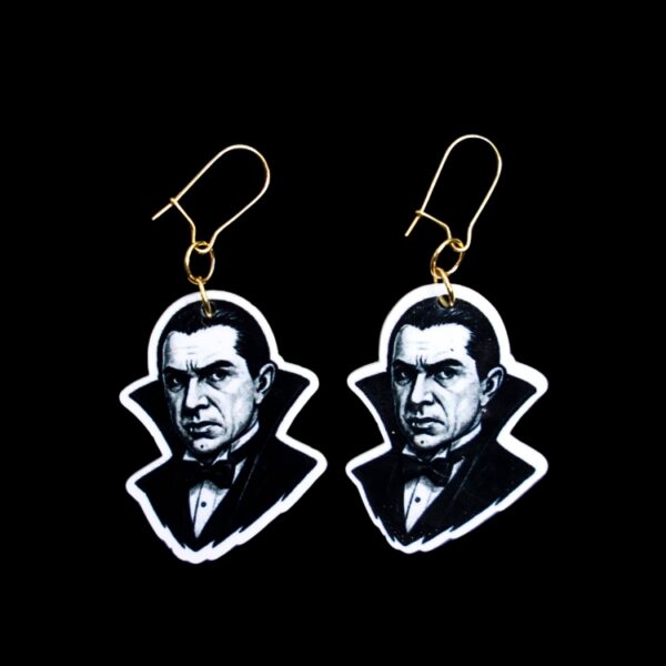 Dracula Earrings. These earrings are made with acrylic and hand heat pressed. Comes with 18k plated gold hooks that is nickel free. Easily put loop through ear and hook back so the earring doesn’t fall out.