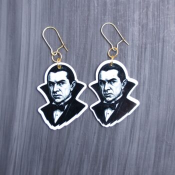 Dracula Earrings. These earrings are made with acrylic and hand heat pressed. Comes with 18k plated gold hooks that is nickel free. Easily put loop through ear and hook back so the earring doesn’t fall out.