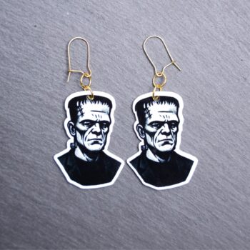 Frank Earrings. These earrings are made with acrylic and hand heat pressed. Comes with 18k plated gold hooks that is nickel free. Easily put loop through ear and hook back so the earring doesn’t fall out.