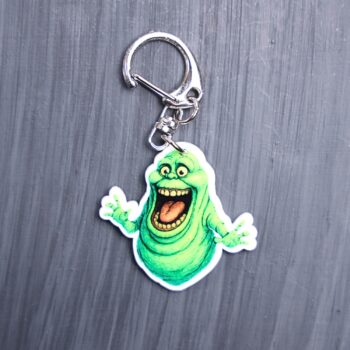 Green Ghost Bag Tag. This bag tag is made with acrylic and heat pressed. Comes with lobster clasp topper that easily hooks to a bag, zippers, and lanyards for fun display and swivels. White backside.