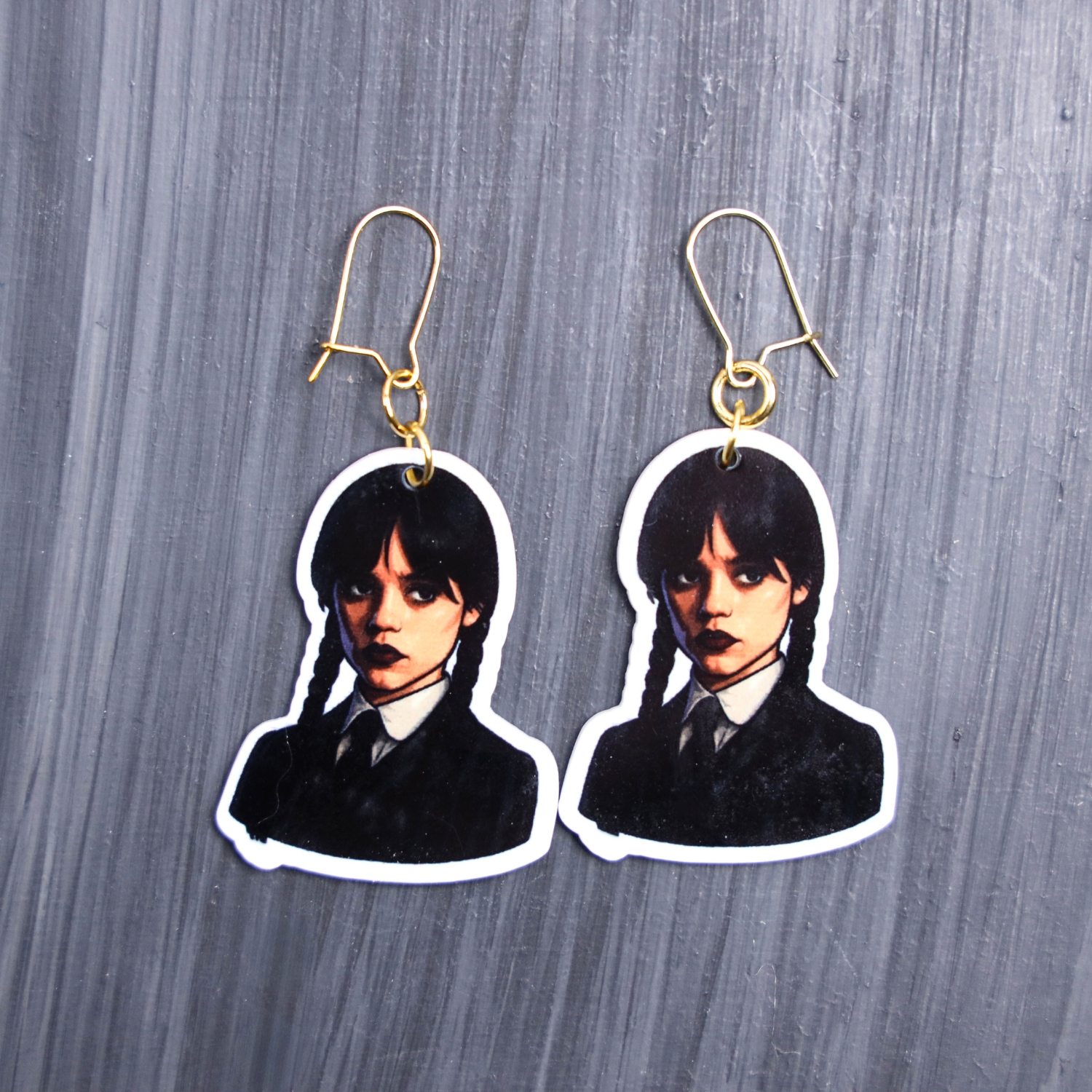 Monday's Child Earrings. These earrings are made with acrylic and hand heat pressed. Comes with 18k plated gold hooks that is nickel free. Easily put loop through ear and hook back so the earring doesn’t fall out.