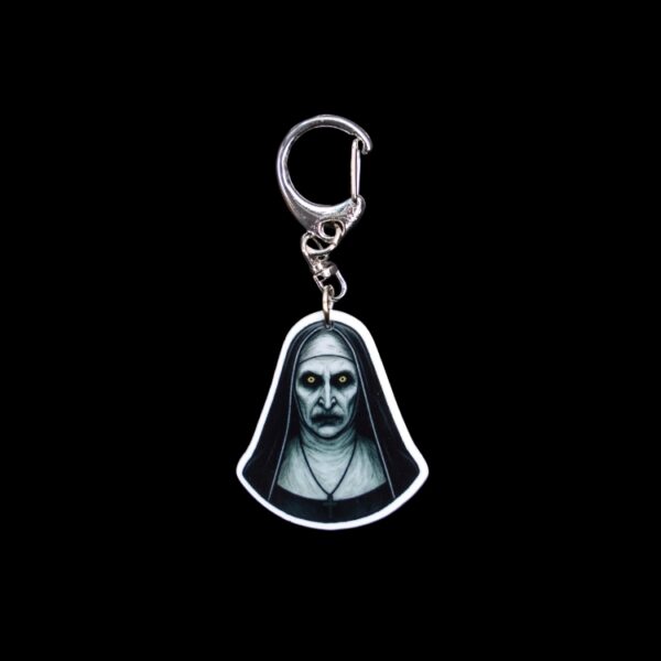 Nun Bag Tag. This bag tag is made with acrylic and heat pressed. Comes with lobster clasp topper that easily hooks to a bag, zippers, and lanyards for fun display and swivels. White backside.