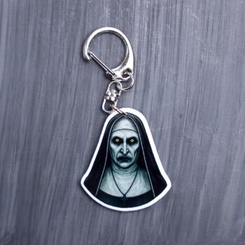 Nun Bag Tag. This bag tag is made with acrylic and heat pressed. Comes with lobster clasp topper that easily hooks to a bag, zippers, and lanyards for fun display and swivels. White backside.