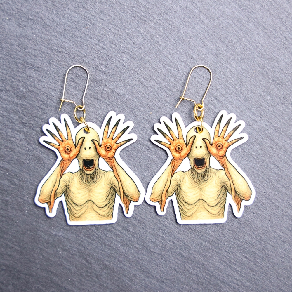 Pale One Earrings. These earrings are made with acrylic and hand heat pressed. Comes with 18k plated gold hooks that is nickel free. Easily put loop through ear and hook back so the earring doesn’t fall out.