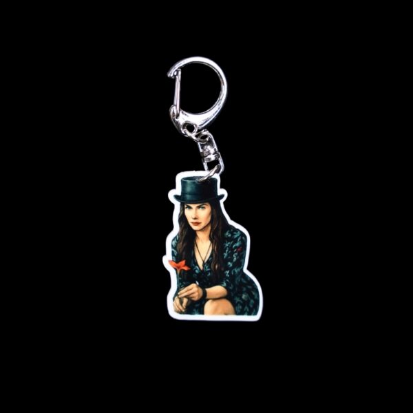 She's The Hat Bag Tag. This bag tag is made with acrylic and heat pressed. Comes with lobster clasp topper that easily hooks to a bag, zippers, and lanyards for fun display and swivels. White backside.