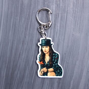 She's The Hat Bag Tag. This bag tag is made with acrylic and heat pressed. Comes with lobster clasp topper that easily hooks to a bag, zippers, and lanyards for fun display and swivels. White backside.