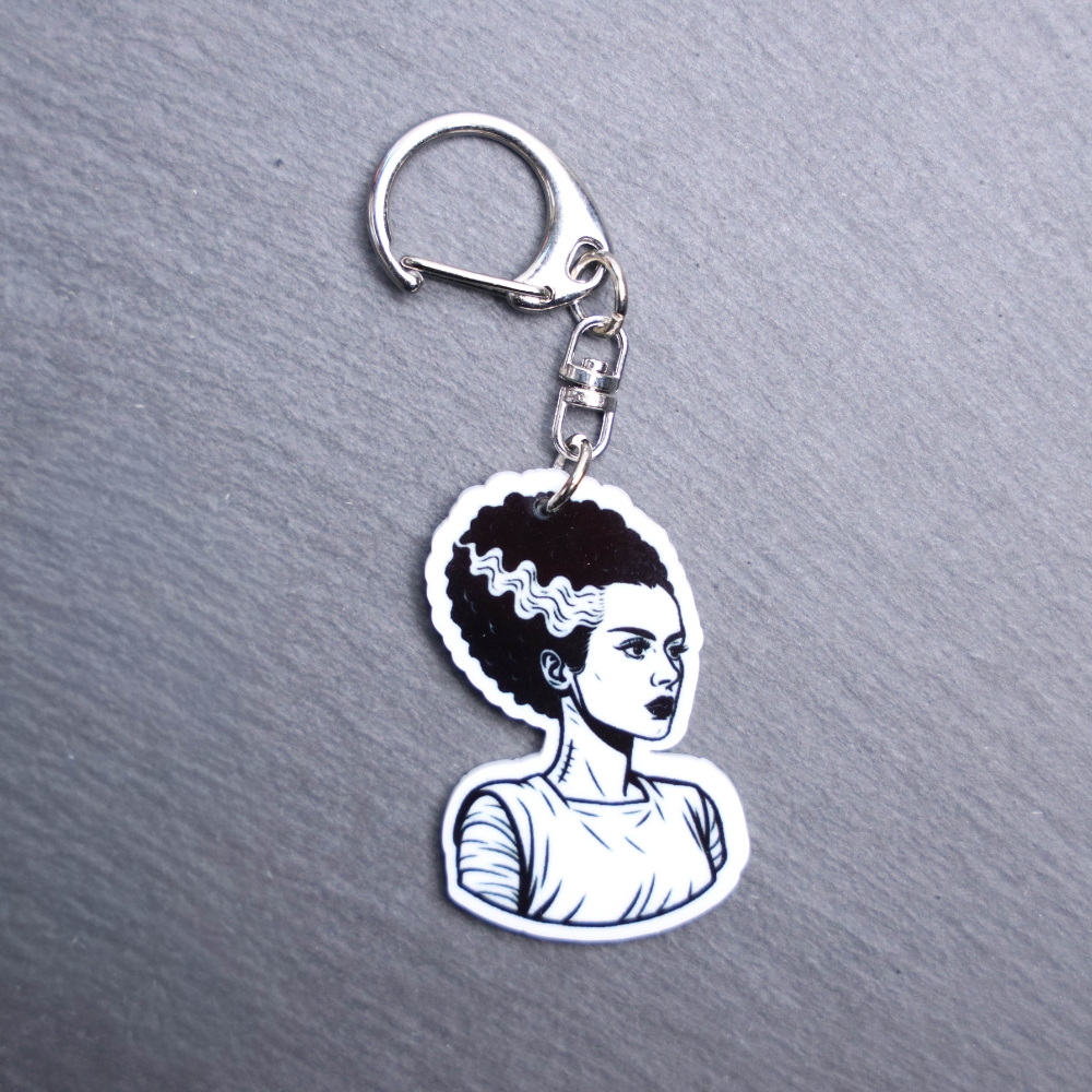 Bride Bag Tag. This bag tag is made with acrylic and heat pressed. Comes with lobster clasp topper that easily hooks to a bag, zippers, and lanyards for fun display and swivels. White backside.