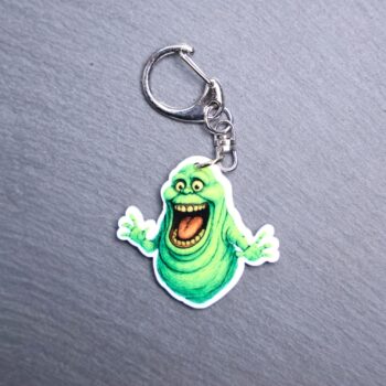 Green Ghost Bag Tag. This bag tag is made with acrylic and heat pressed. Comes with lobster clasp topper that easily hooks to a bag, zippers, and lanyards for fun display and swivels. White backside.