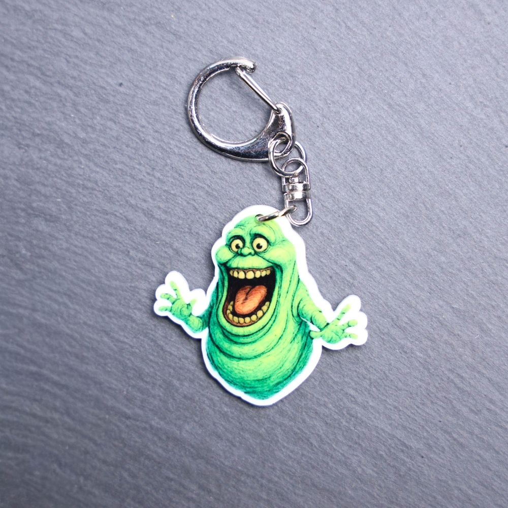 Green Ghost Bag Tag. This bag tag is made with acrylic and heat pressed. Comes with lobster clasp topper that easily hooks to a bag, zippers, and lanyards for fun display and swivels. White backside.