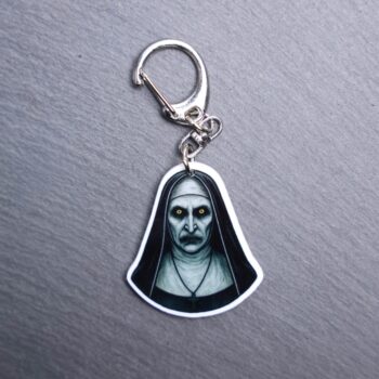 Nun Bag Tag. This bag tag is made with acrylic and heat pressed. Comes with lobster clasp topper that easily hooks to a bag, zippers, and lanyards for fun display and swivels. White backside.