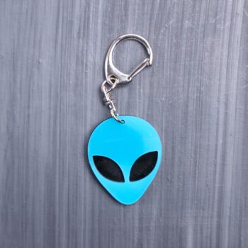 Alien Head Neon Blue Bag Tag with black eyes and black backing. Acrylic designed charm with a swivel lobster snap hook in high quality metal alloy.