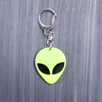 Alien Head Neon Yellow Bag Tag with black eyes and black backing. Acrylic designed charm with a swivel lobster snap hook in high quality metal alloy.