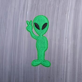Alien Peace Sign Patch in green holding up the peace sign. Beautifully embroidered design with an adhesive for easy application to your favorite bag or article of clothing.