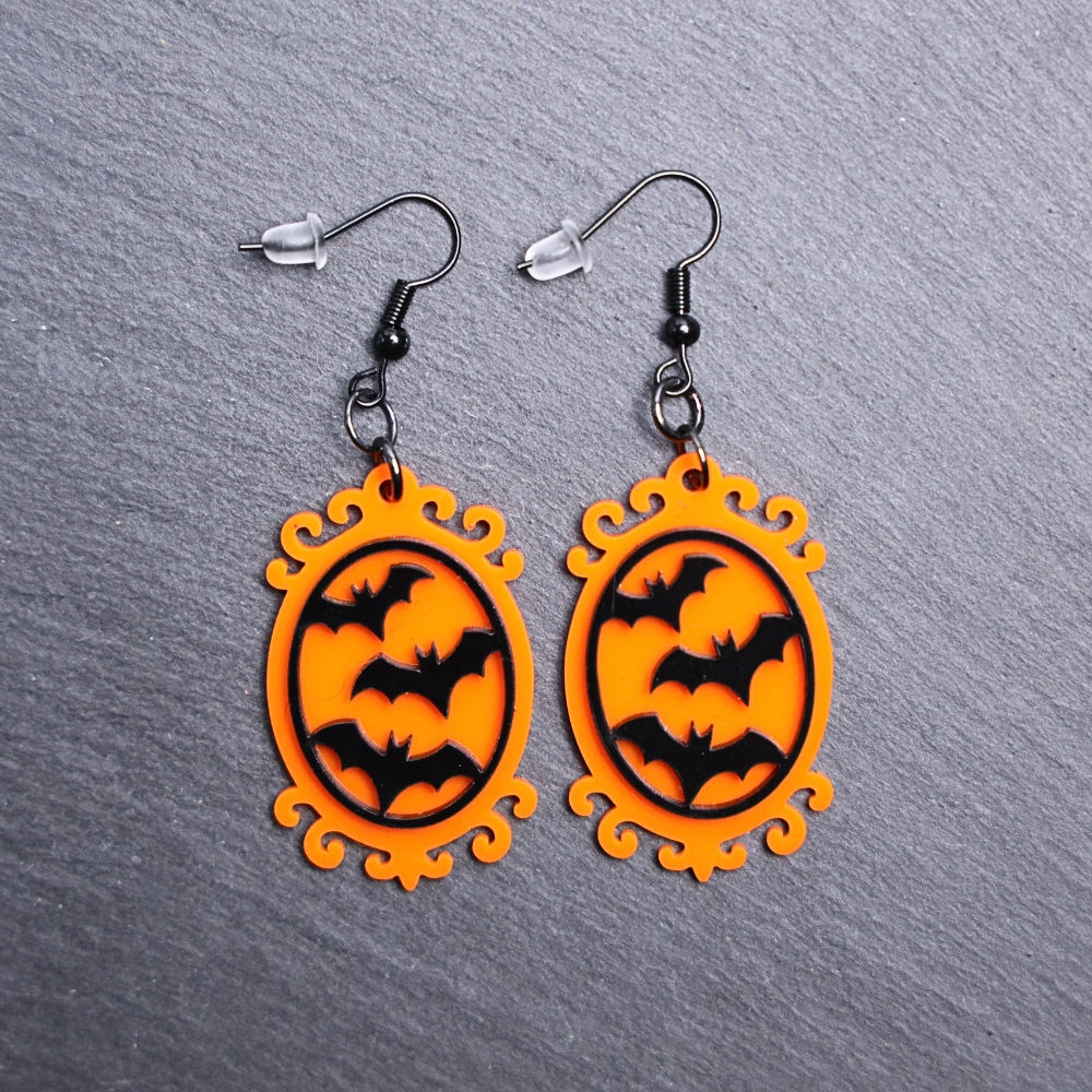 Bat Frame Earrings. These earrings are made with orange and black acrylic. Comes with black hooks that is nickel free.