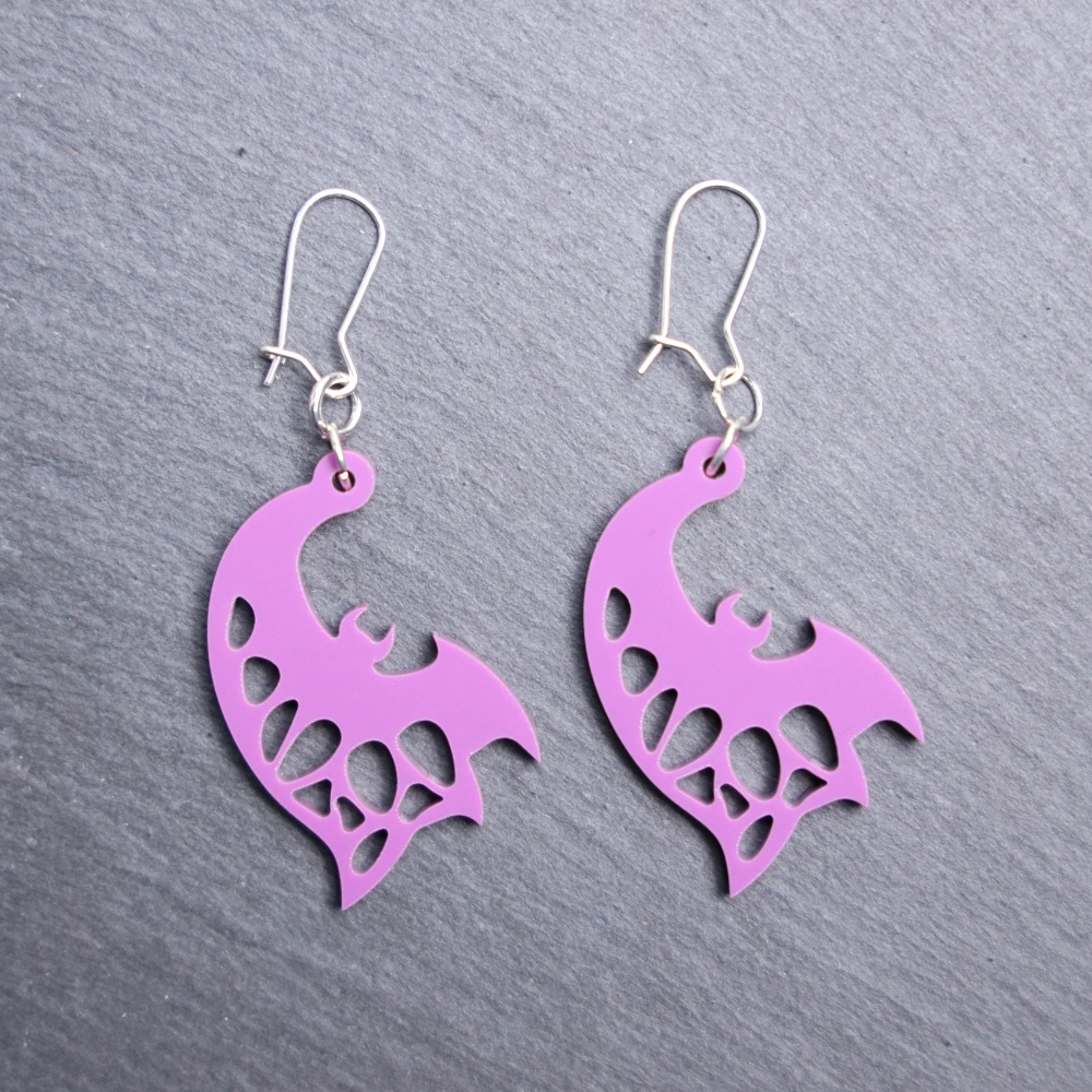 Bat Sideways Purple Earrings. These earrings are made with purple acrylic. Comes with silver hooks that is nickel free.