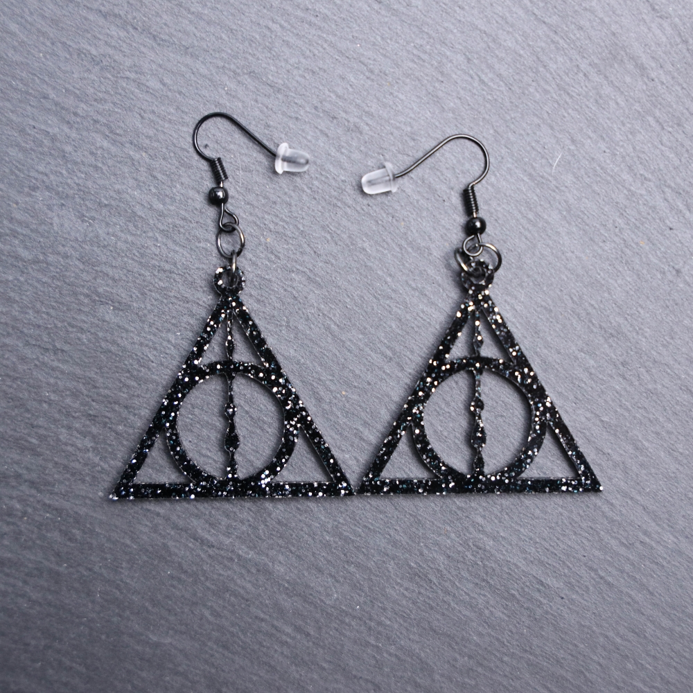 Deathly Hallows Earrings. These earrings are made with glitter black acrylic. Comes with black hooks that is nickel free.