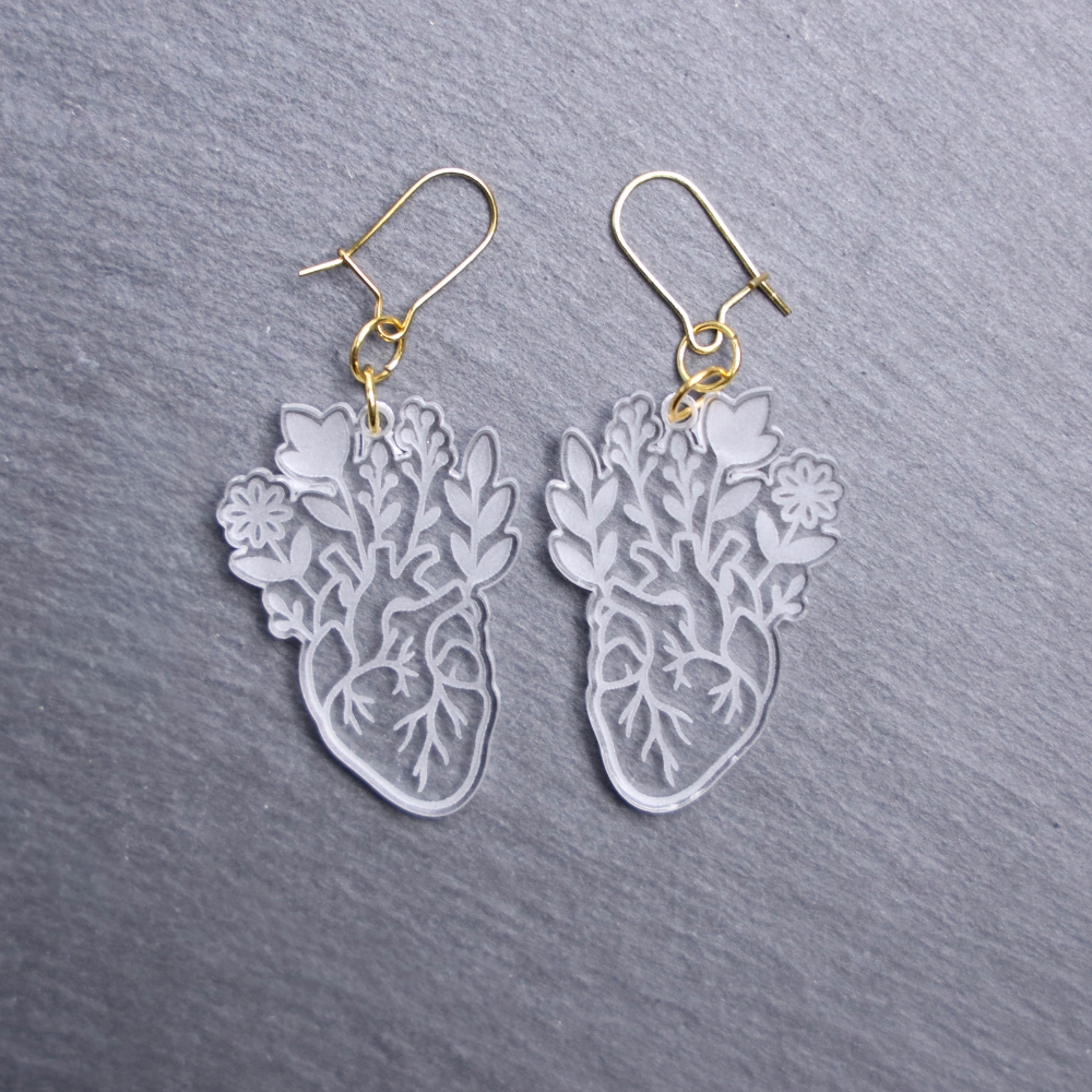 Floral Anatomical Heart Earrings. These earrings are made with clear acrylic. Comes with gold hooks that is nickel free.