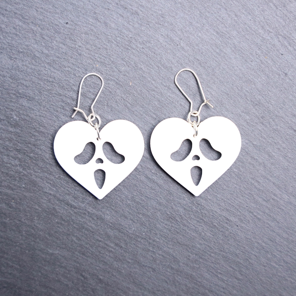 Ghostface Heart Earrings. These earrings are made with white acrylic. Comes with silver hooks that is nickel free.