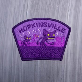 Hopkinsville Goblin Kentucky Patch which is purple with stars and goblins. Beautifully embroidered design with an adhesive for easy application to your favorite bag or article of clothing.