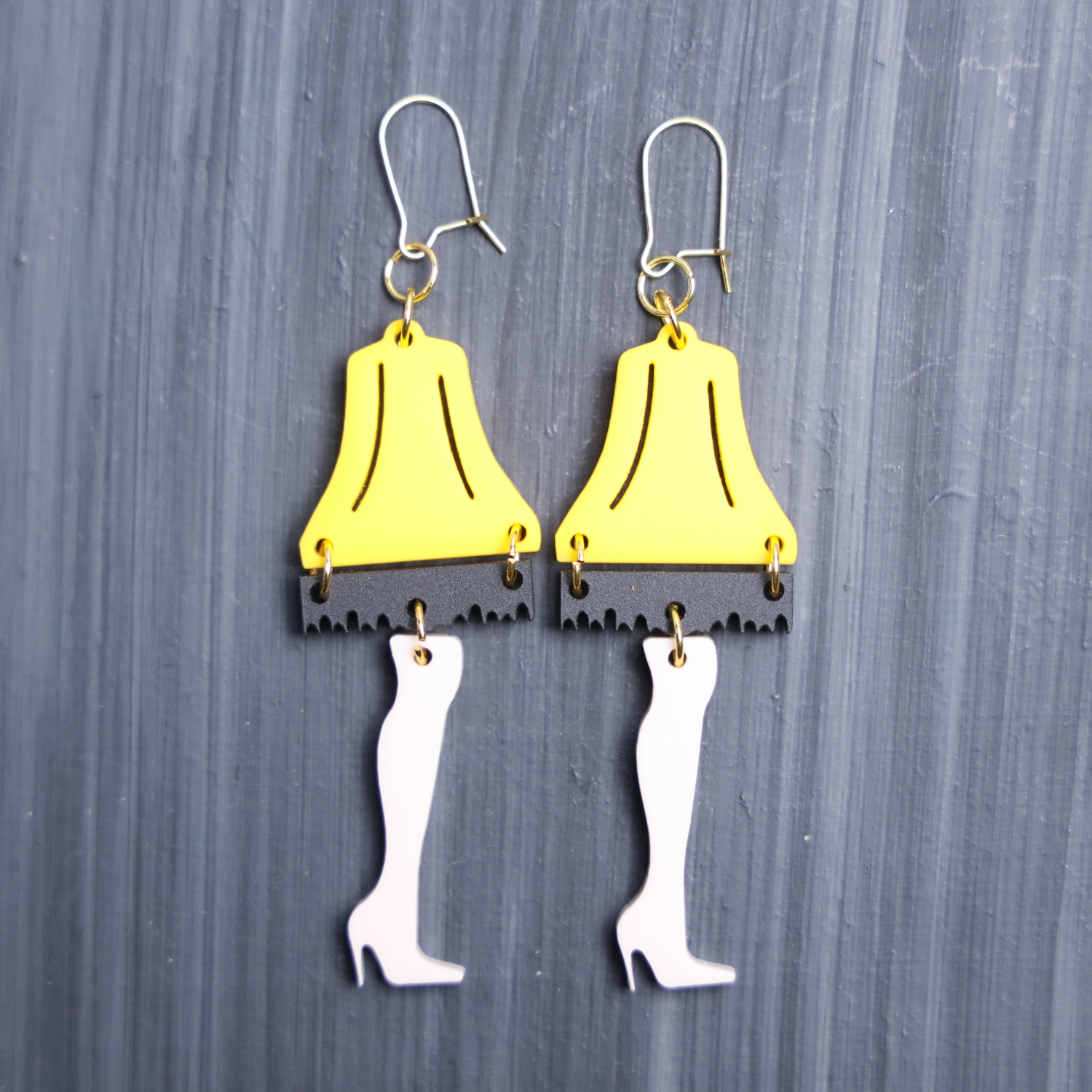 Leg Lamp Earrings. These earrings are made with yellow, black, and french acrylic. Comes with gold hooks that is nickel free.