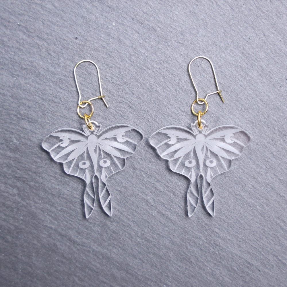 Luna Moth Clear Earrings. These earrings are made with clear acrylic. Comes with gold hooks that is nickel free.