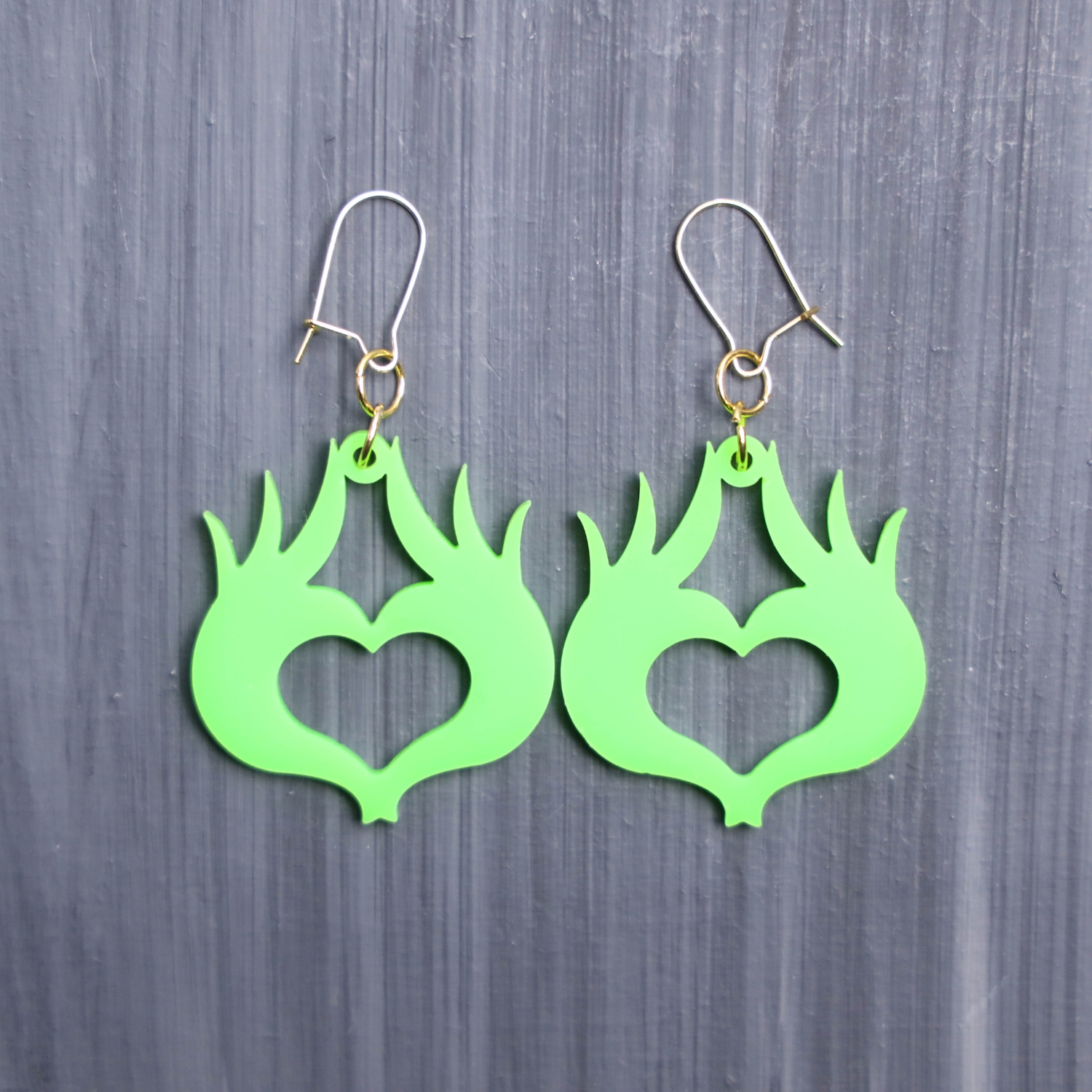 Mean One Heart Earrings. These earrings are made with green acrylic. Comes with gold hooks that is nickel free.