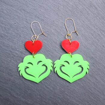 Mean One Red Heart Earrings. These earrings are made with red and green acrylic. Comes with gold hooks that is nickel free.