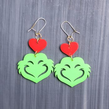 Mean One Red Heart Earrings. These earrings are made with red and green acrylic. Comes with gold hooks that is nickel free.