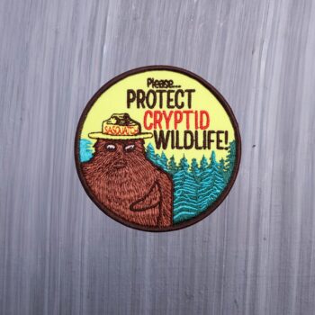 Protect Cryptid Wildlife patch with frog with sasquatch in a hat. Beautifully embroidered design with an adhesive for easy application to your favorite bag or article of clothing.