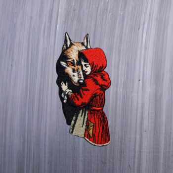 Red Riding Hood Wolf Patch with red young girl and beautiful wolf. Beautifully embroidered design with an adhesive for easy application to your favorite bag or article of clothing.