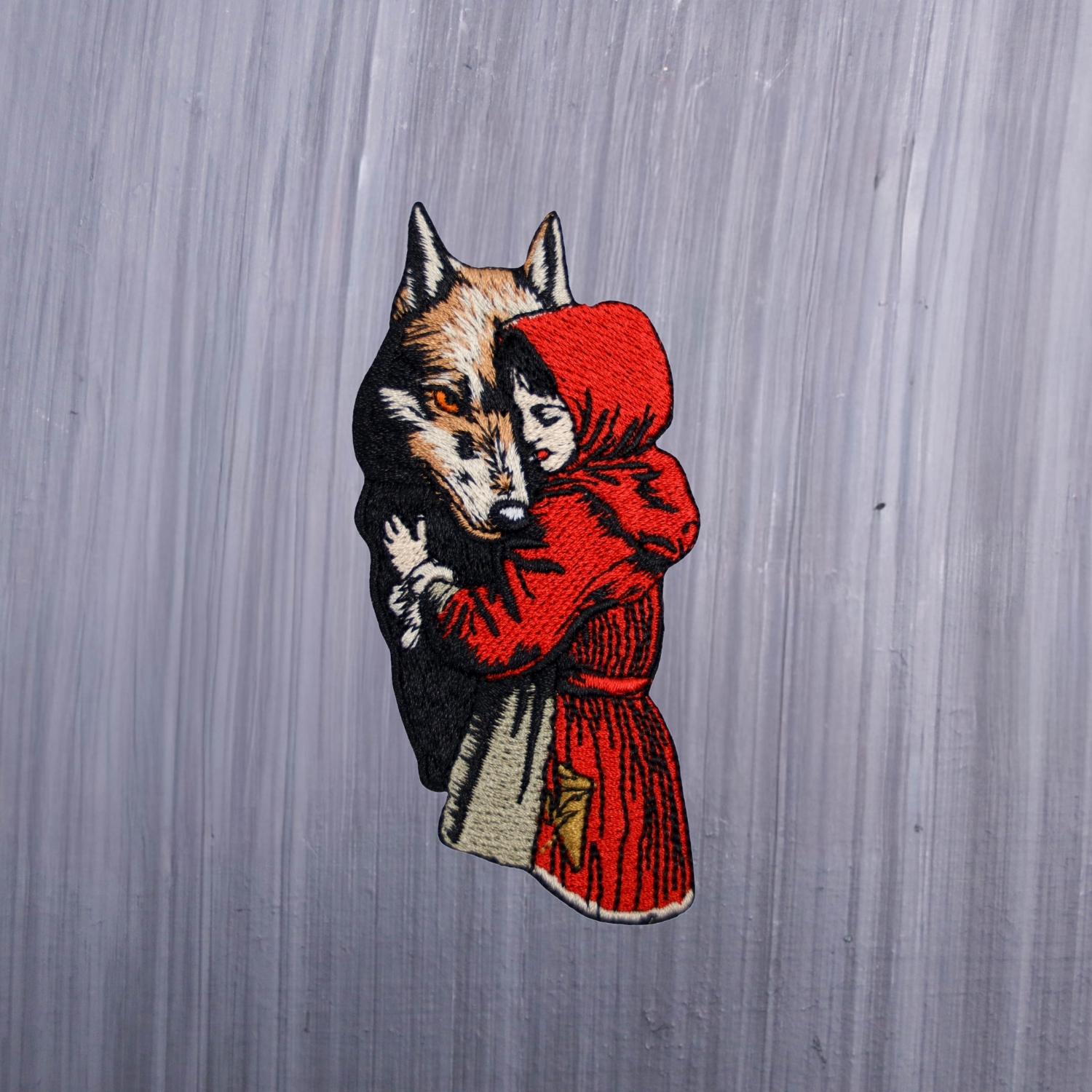 Red Riding Hood Wolf Patch with red young girl and beautiful wolf. Beautifully embroidered design with an adhesive for easy application to your favorite bag or article of clothing.