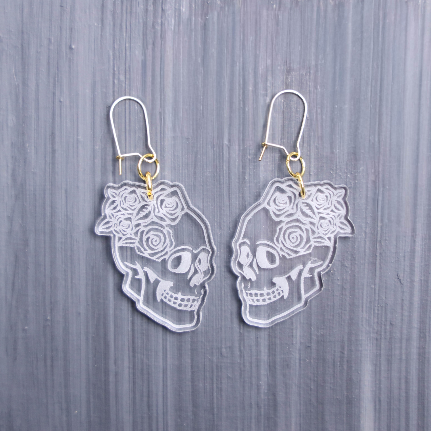 Skull Roses Clear Earrings. These earrings are made with clear acrylic. Comes with gold hooks that is nickel free.
