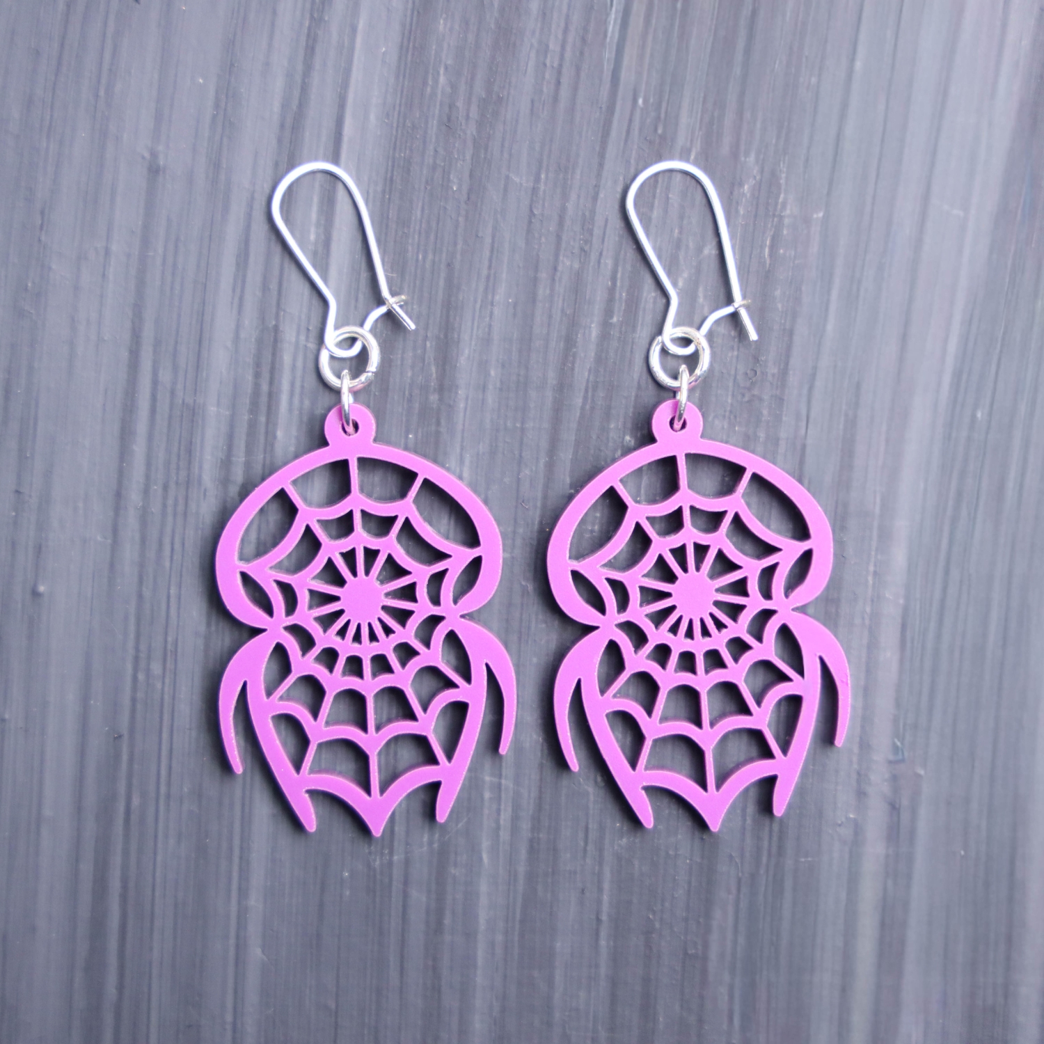 Spider Catcher Purple Earrings. These earrings are made with purple acrylic. Comes with silver hooks that is nickel free.