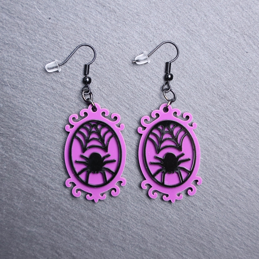 Spider Frame Earrings. These earrings are made with purple and black acrylic. Comes with black hooks that is nickel free.