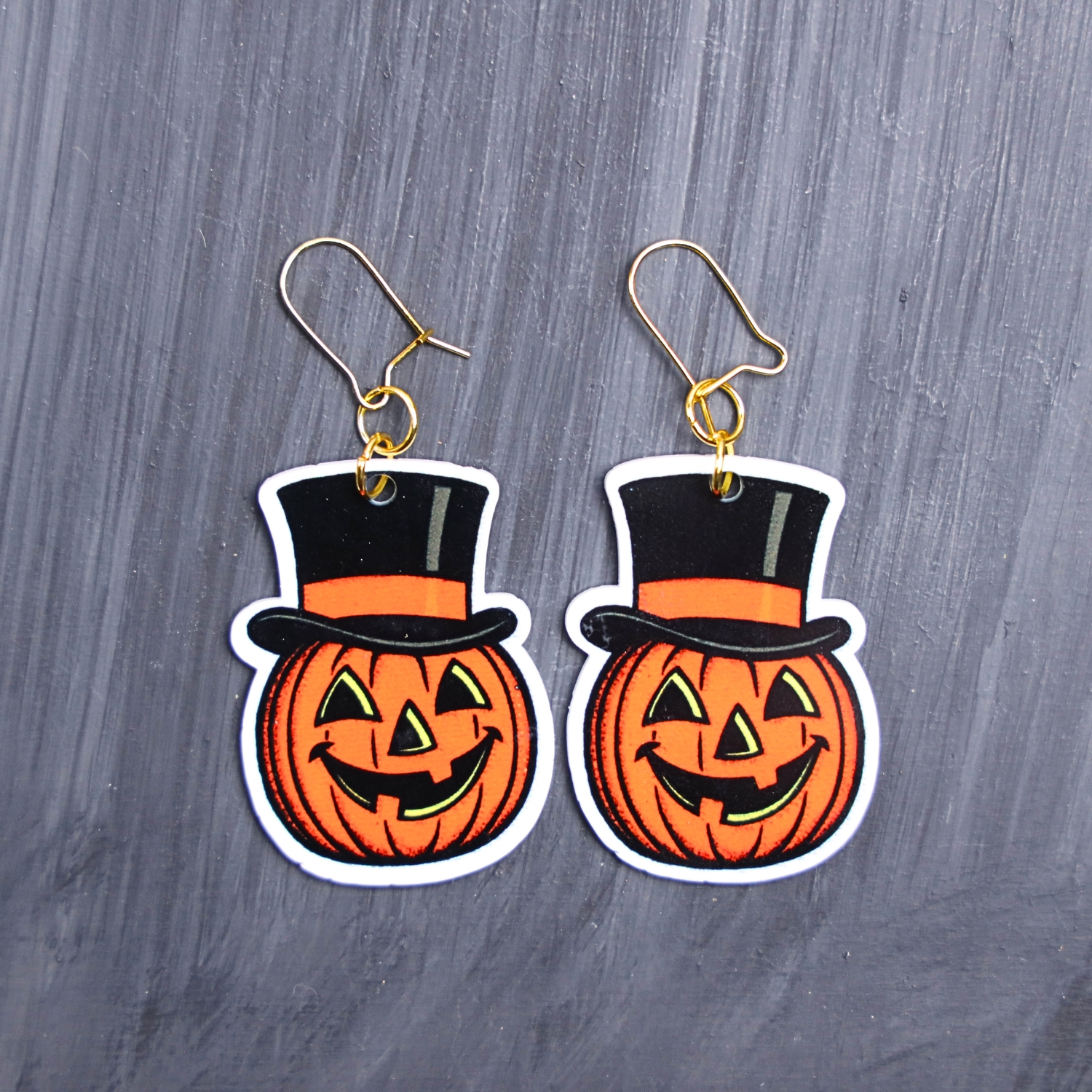 Vintage Jack Earrings. These earrings are made with acrylic and hand heat pressed. Comes with 18k plated gold hooks that is nickel free. Easily put loop through ear and hook back so the earring doesn’t fall out.