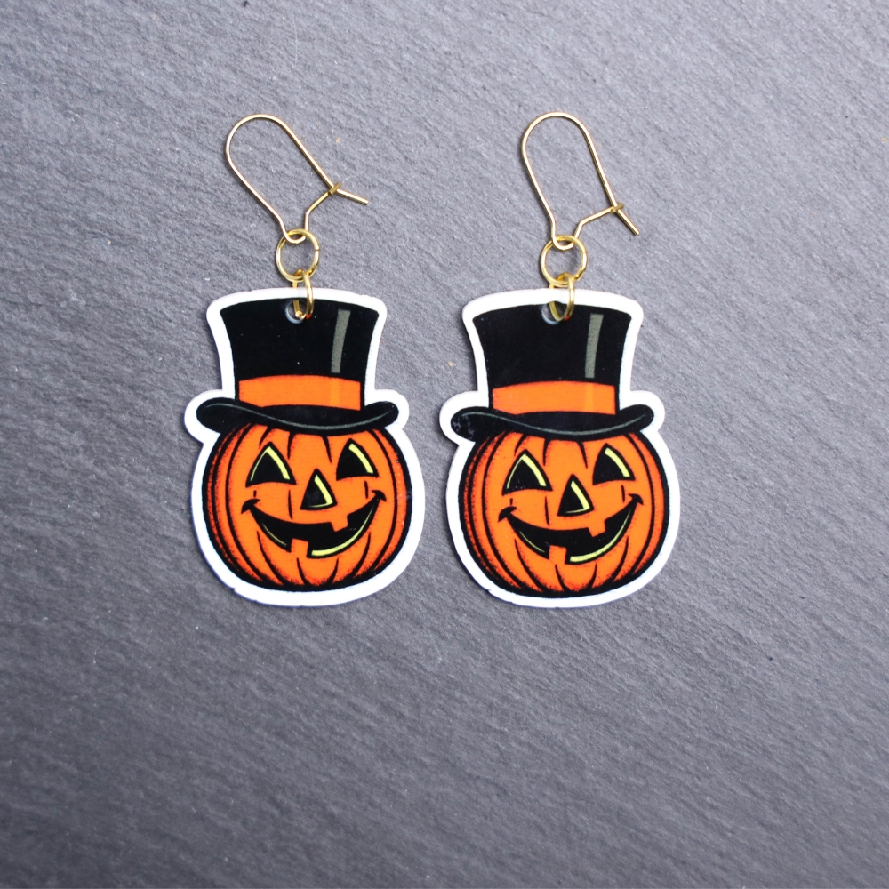 Vintage Jack Earrings. These earrings are made with acrylic and hand heat pressed. Comes with 18k plated gold hooks that is nickel free. Easily put loop through ear and hook back so the earring doesn’t fall out.