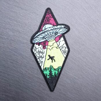 Alien abduction patch with spaceship, light beam, and trees. Beautifully embroidered design with an adhesive for easy application to your favorite bag or article of clothing.