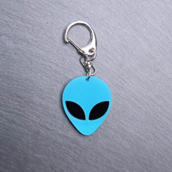 Alien Head Neon Blue Bag Tag with black eyes and black backing. Acrylic designed charm with a swivel lobster snap hook in high quality metal alloy.