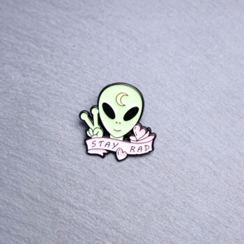 Alien Stay Rad Enamel Pin green alien with pink and moon on his head. These enamel pins are made with metal. These enamel pins are colorful, with a black backing.
