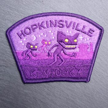 Hopkinsville Goblin Kentucky Patch which is purple with stars and goblins. Beautifully embroidered design with an adhesive for easy application to your favorite bag or article of clothing.