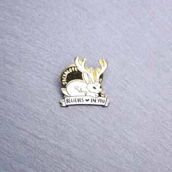 Jackalope Believe In You Enamel Pin in gold and white. These enamel pins are made with metal. These enamel pins are colorful, with a gold colored backing.
