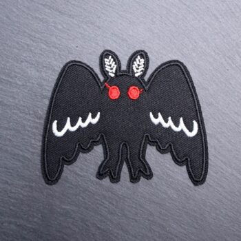 Mothman Big Wings Patch in white and black with red eyes. Beautifully embroidered design with an adhesive for easy application to your favorite bag or article of clothing.