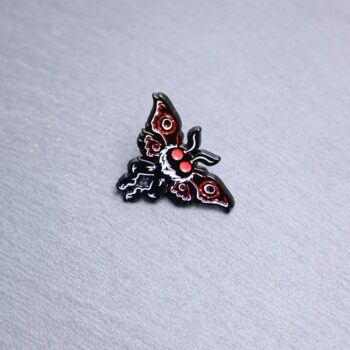 Mothman Detailed Enamel Pin in gray, red, and black. These enamel pins are made with metal. These enamel pins are colorful, with a black backing.