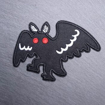 Mothman Walking Patch in white and black with red eyes. Beautifully embroidered design with an adhesive for easy application to your favorite bag or article of clothing.